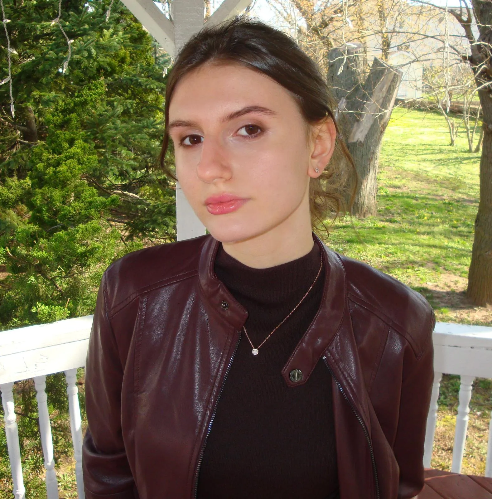 An individual wearing a red shirt, posing for a portrait.