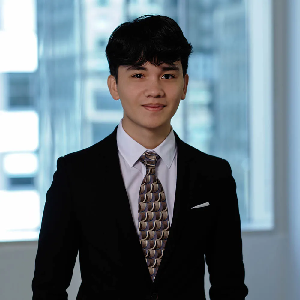 A male in a suit, posing for a photo. 